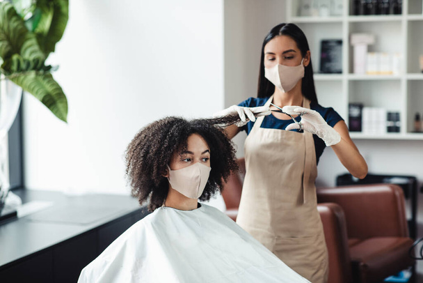 African american girl cutting split ends at beauty salon, free space - Photo, Image