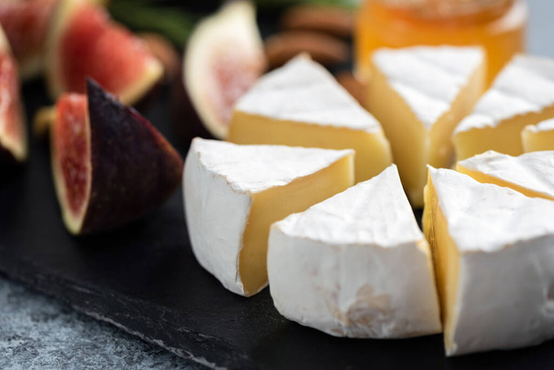 Sliced camembert cheese and figs - Photo, Image