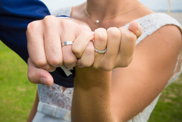 bride and groom show rings for wedding after celebration - Fotó, kép