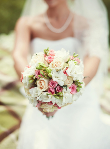 Bride in a white dress  with a bouquet - Foto, Imagen