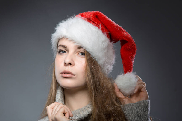christmas girl with santa claus hat wearing a turtleneck  - Photo, Image
