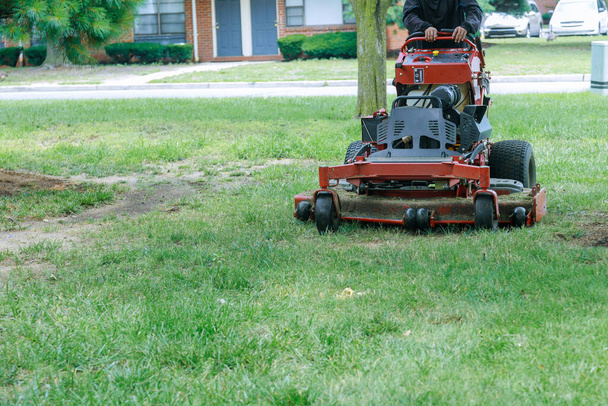 Man using a lawn mower a gardener cutting grass by lawn mower - Photo, Image
