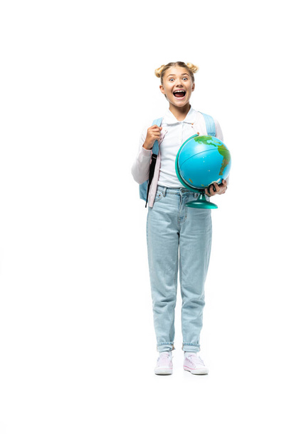 Küre ve sırt çantalı heyecanlı okul çocuğu beyaz arka planda kameraya bakıyor. - Fotoğraf, Görsel