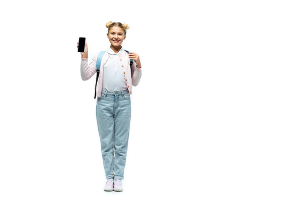 Schoolkid pointing with finger at smartphone on white background - Foto, Imagem