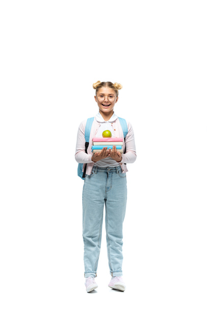Schoolgirl in eyeglasses holding books and apple on white background - Valokuva, kuva