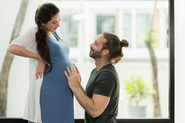 Handsome beard man take care his pregnant wife. Happy family concept. - Foto, imagen
