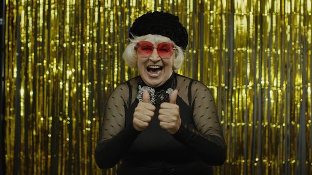 Pozitif yaşlı, güneş gözlüklü yaşlı kadın portresi. Eğleniyor ve gülümsüyor - Fotoğraf, Görsel