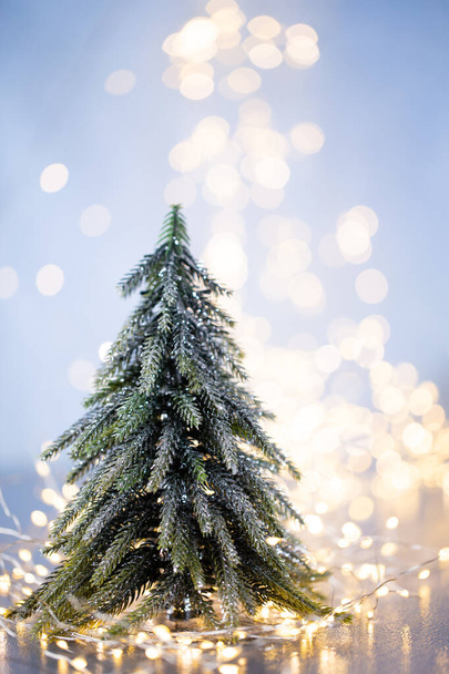 Christmas tree on blue bokeh background. - Foto, afbeelding
