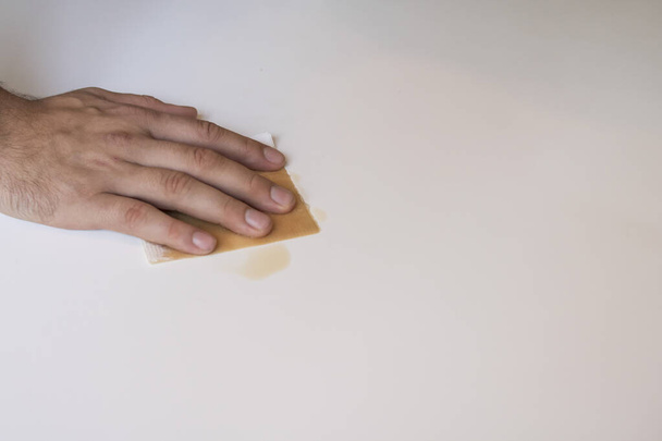 The guy wipes the table with a white disposable napkin - Photo, Image