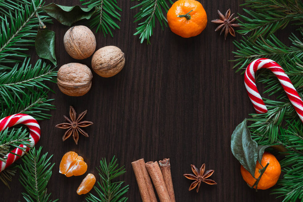 Christmas card. Tangerines, nuts, spruce, candy, star - Фото, изображение