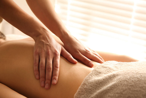 Young woman receiving back massage in spa salon, closeup - Foto, Bild