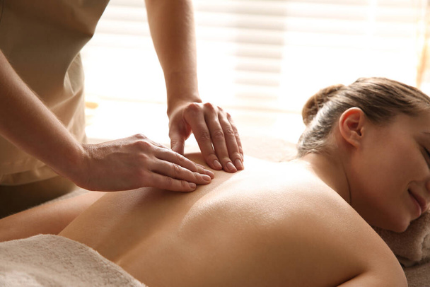 Young woman receiving back massage in spa salon, closeup - Foto, Imagen