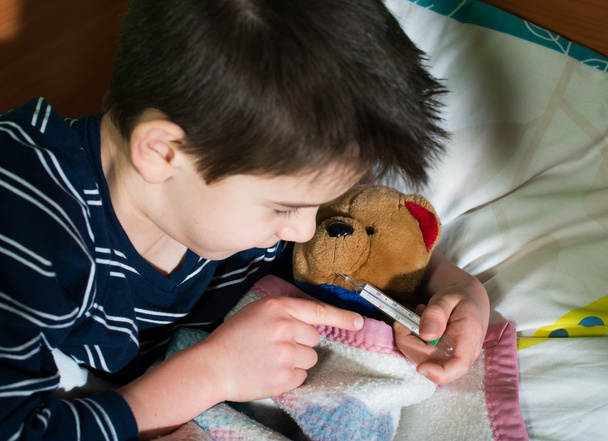 oyuncak ayı ile yatakta hasta çocuk - Fotoğraf, Görsel