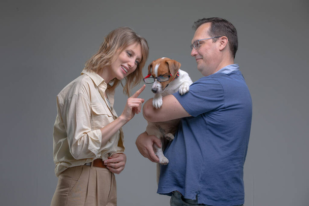 Happy family in studio with pet - Foto, imagen