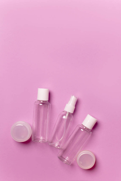 Cosmetic bottles and jars on a pink background - Fotoğraf, Görsel