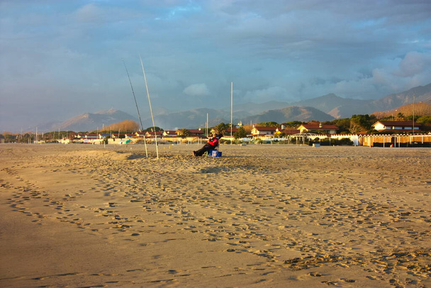 relaxing walks on the sandy beach of Versilia on a sunny day in Italian winter - Photo, Image