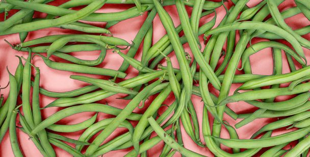 Raw green beans on a colored background, green asparagus, summer harvest. - Photo, Image