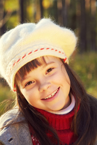 closeup portrait of a cute smiling little girl in a coat and beret in autumn. - Fotografie, Obrázek