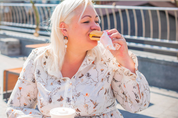 Chubby nice happy plus size woman eat burger in good mood outdoor, stop diet happy life and body positive concept - Photo, Image