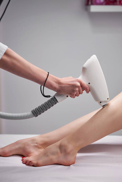 adorable woman receiving modern body lifting therapeutic massage by professional cosmetologist - Valokuva, kuva