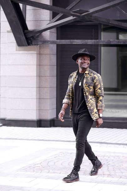 african american famous man walk in city streets, wearing fashionable clothes - Photo, image