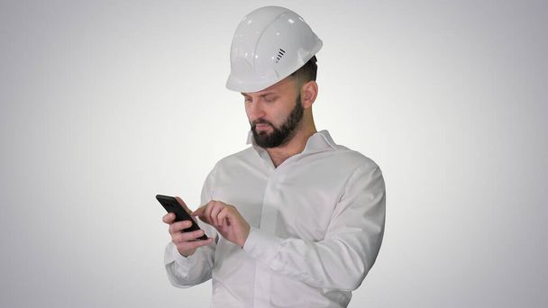 Smart engineer in white shirt and safety engineering hat using s - Fotó, kép