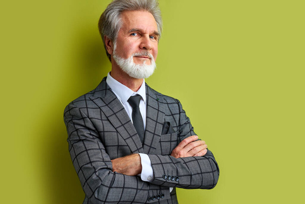 handsome rich man in suit isolated over green background - Foto, afbeelding