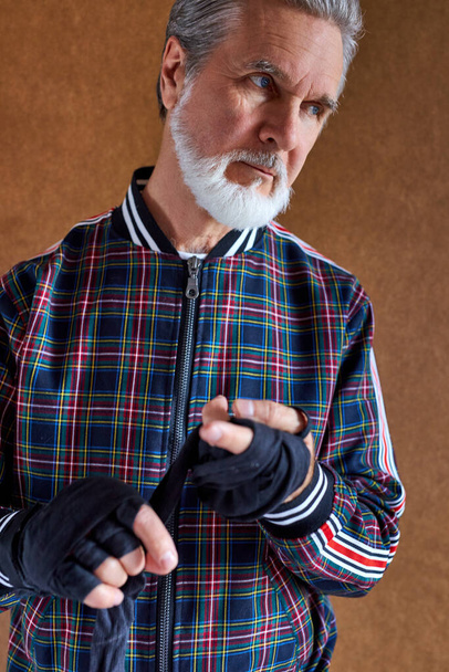 confident senior man wearing bandage on hands - Zdjęcie, obraz