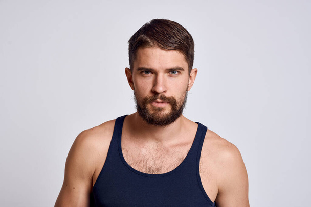 retrato de un hombre con una camiseta sobre un modelo de cuidado del cuero cabelludo masajeador de fondo claro - Foto, Imagen