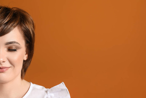 Young woman with beautiful short hair on color background - Photo, image