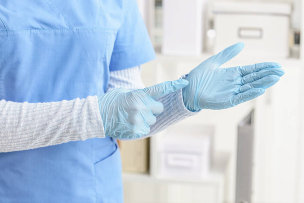 Лікар з медичними рукавичками в клініці
 - Фото, зображення