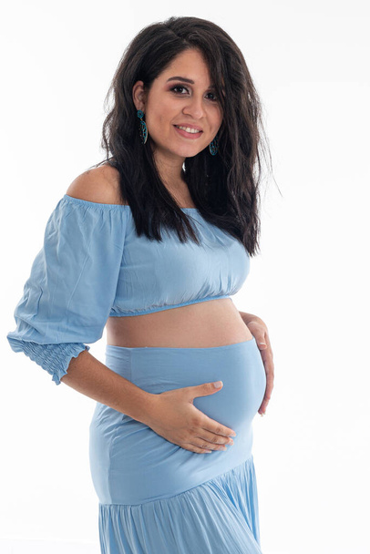 Happy smiling pregnant woman touching her belly isolated on white background. Pregnancy concept studio portrait Mother expecting baby. Baby tea. - Foto, immagini