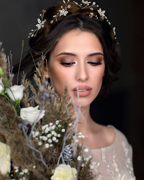 Beautiful woman in a luxurious wedding dress. Portrait of the bride with a large bouquet in her hands. - Foto, immagini