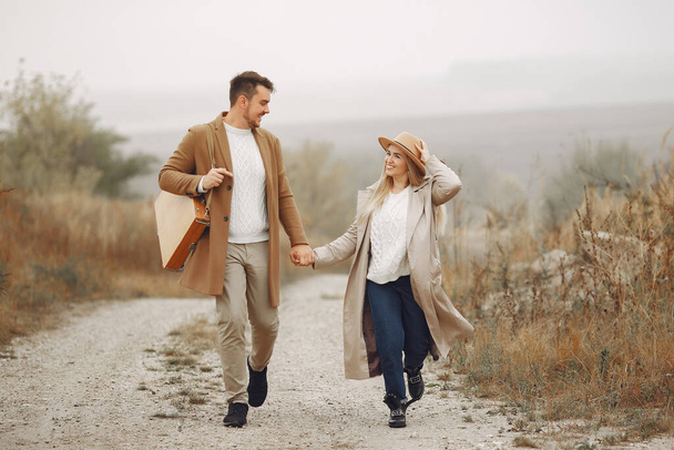 Beautiful couple spend time in a autumn field - Photo, Image