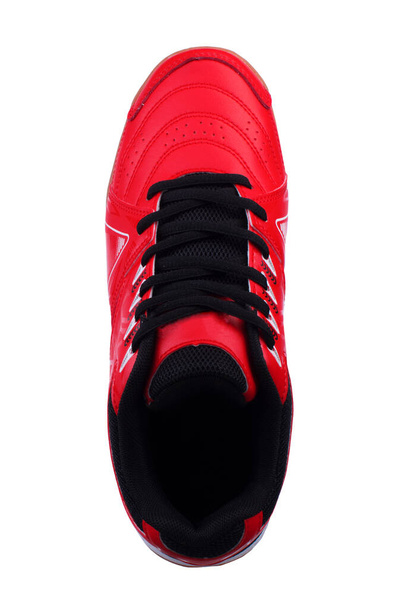 Red sneakers with black laces and white stripes on a white background. - Photo, Image