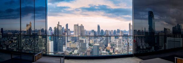 Вид на город Бангкок с крыши здания отеля с высоким зданием и голубым небом на фоне. - Фото, изображение