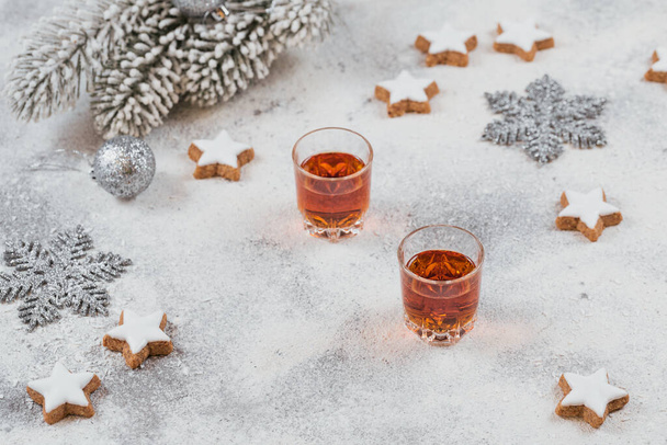 Whiskey, brandy or liquor, cookies and chrastmas decorations on white background - Photo, image