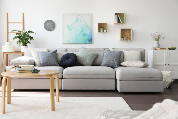 Elegant living room with comfortable sofa and wooden table. Interior design - Fotografie, Obrázek