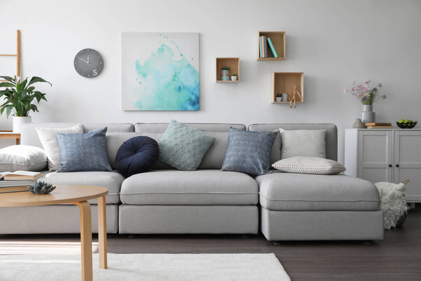 Elegant living room with comfortable sofa and wooden table. Interior design - Фото, изображение