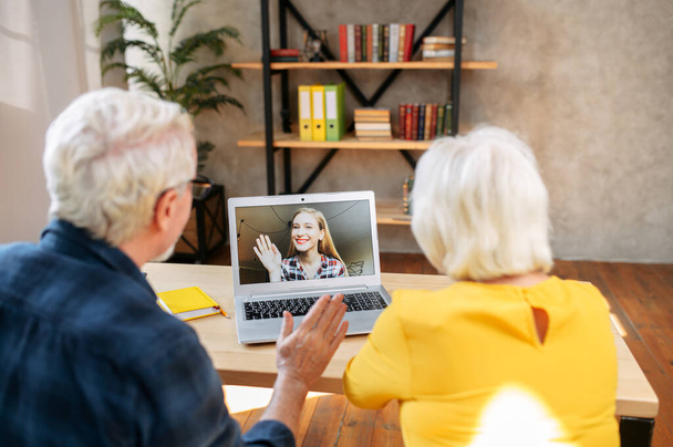Grandparents have online meeting with a granddaughter - Foto, Imagen