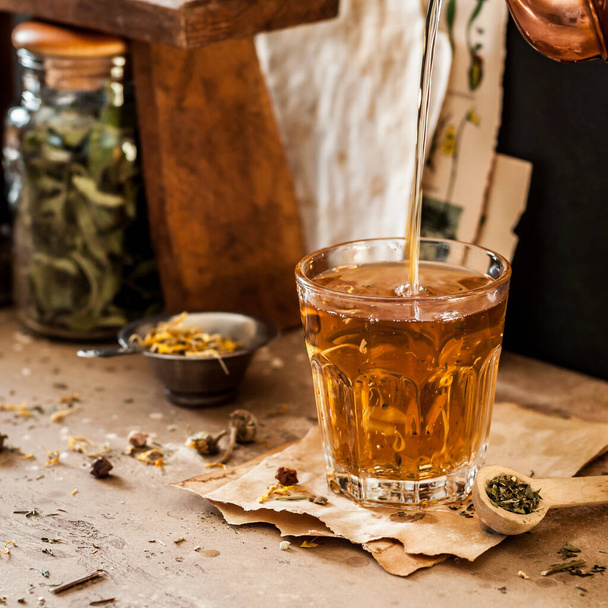 Pouring Herbal Tea into a Glass, Variety of Dried Herb Mixes, square - Foto, Bild