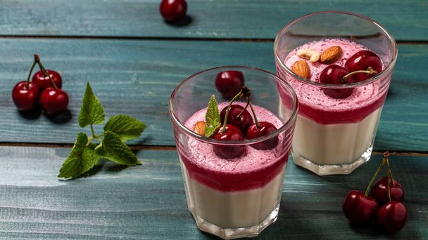 Traditional Italian dessert panna cotta with cherry jelly. Summer yogurt dessert. Food recipe background. Close up. - Photo, Image