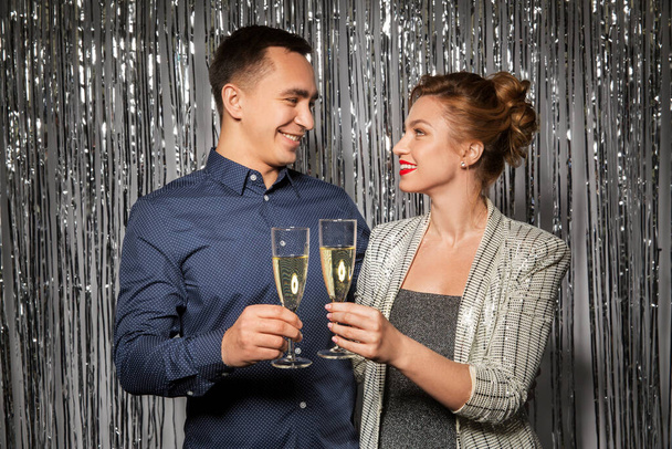 happy couple toasting champagne glasses at party - Фото, изображение