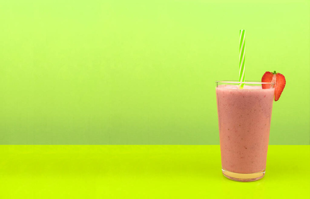 Diet and vegetarian fruit smoothie. Fruit cocktail in a glass with straws. A refreshing milkshake for vegetarians. Healthy and wholesome food. Background for text - Photo, Image