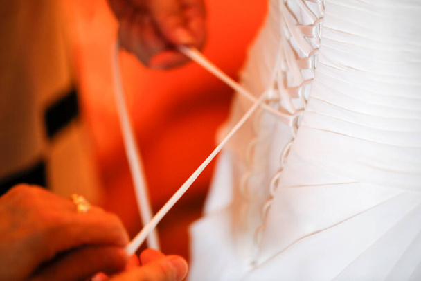 dressing the bride, lacing the bodice dress. High quality photo - Photo, Image