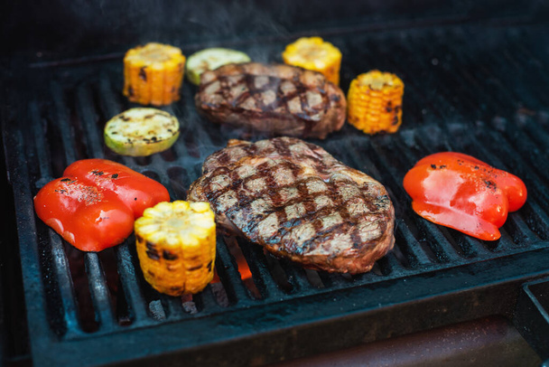Beef steaks on the grill with flames - Photo, image