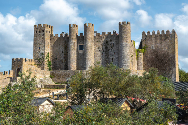 Obidos ancient castle seen behind a medieval market, Portugal - Photo, Image