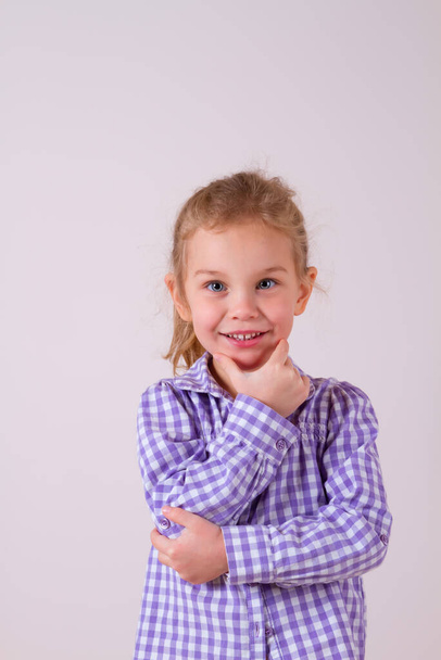 A child girl portrait in checkered shirt isolated on clear white background - Foto, Bild