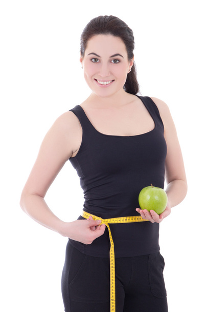 sporty woman measuring her waist and holding apple isolated on w - Φωτογραφία, εικόνα