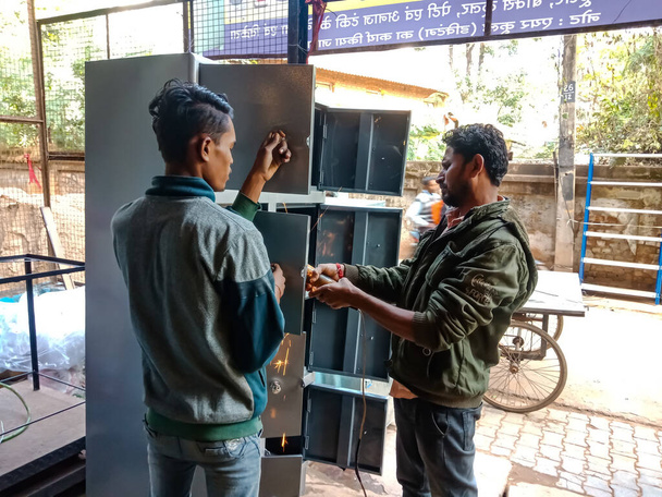 DISTRICT KATNI, INDIA - JANUARY 08, 2020: Two indian labours making almirah on steel workshop. - Фото, зображення